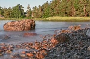 Early morning along a rocky coastline in summer. photo