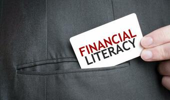 Card with FINANCIAL LITERACY text in pocket of businessman suit. Investment and decisions business concept. photo