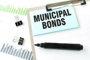 Paper plate, marker, diagram, chart and office tools. Text MUNICIPAL BONDS photo