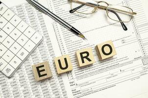 euro Word Written In Wooden Cubes on documents photo