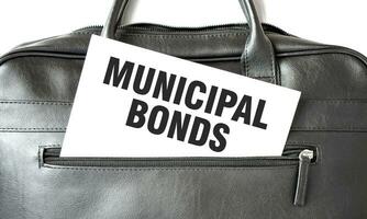 Text MUNICIPAL BONDS writing on white paper sheet in the black business bag. Business concept photo