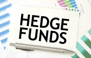 HEDGE FUNDS on paper sheet on charts photo