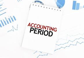 White notepad with text ACCOUNTING PERIOD on the financial documentation. Finance and business concept photo