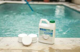 Pool cleaning chlorine tablets kit, pool cleaning chlorine tablets close up on the edge of a swimming pool, pool sanitizing chlorine tablets concept photo