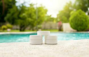 Chlorine tablets for swimming pool cleaning, close up of chlorine tablets on the edge of a swimming pool, chlorine tablets for swimming pool disinfection photo