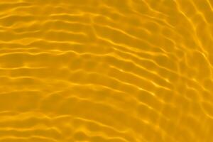 Golden water with ripples on the surface. Defocus blurred transparent gold colored clear calm water surface texture with splashes and bubbles. Water waves with shining pattern texture background. photo