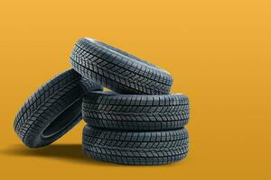 Car tires isolated on yellow background photo