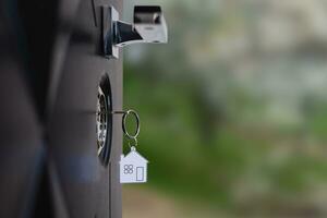 A key in a lock with house icon on it photo