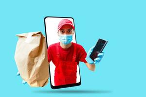 Delivery man in cap k t-shirt uniform face mask gloves hold cardboard box isolated on color background. Service quarantine pandemic coronavirus virus 2019-ncov concept photo