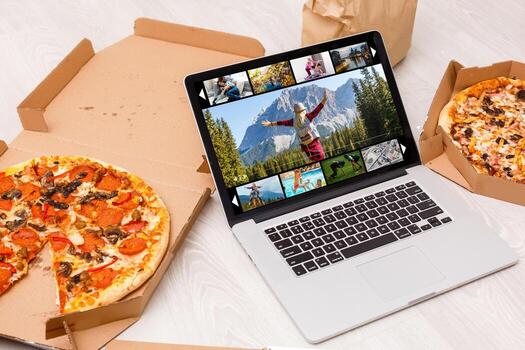 An ordinary workplace of a blogger with a modern laptop and an interface of an application for video editing process. photo