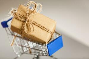 A huge gift with a craft ribbon in a shopping cart photo