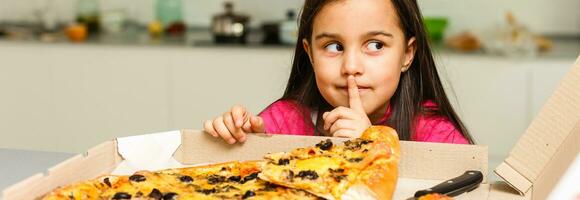 Little girl eating pizza photo