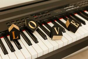 wooden word love on piano wedding concept photo