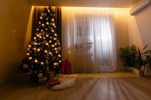 A living room at Christmastime lit only by the Christmas tree. photo