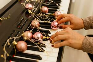 A piano with christmas lights and tree photo