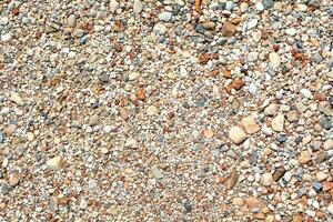 Small round stones background. Stone texture. Rough surface of small pebble stone. photo