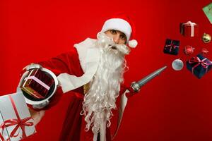 santa claus with fire extinguisher. Isolated on red background photo