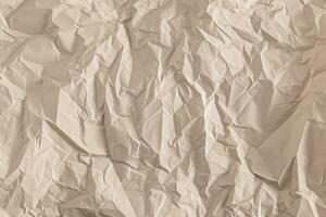 The texture of the crumpled paper is light brown. abstract paper background. A copy of the space. layout, blank template. photo