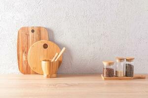 Front view of the wooden countertop of an eco-friendly kitchen with jars for storing bulk products and cutting boards. space for text. photo