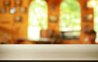 Empty wooden table in front of abstract blurred background of coffee shop . can be used for display or montage your products.Mock up for display of product photo