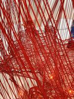 Red thread background. Red thread interweaving. Complex interweaving of fibers. Network net yarn. Abstract backdrop. photo