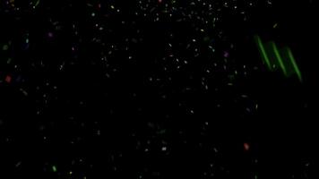 Colorful confetti explodes on a black background video