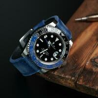 Surabaya, IDN, 2023 - Luxury watch with blue canvas strap on woodcut photo