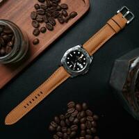 Surabaya, IDN, 2023 - A luxury watch with a brown leather strap, on a dark background and accessory is a jar filled with coffee beans photo