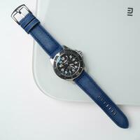 Surabaya, IDN, 2023 - Product photo of a luxury watch with a blue jeans canvas strap with a shiny white board background