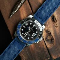 Surabaya, IDN, 2023 - Luxury watch with blue canvas strap on woodcut photo