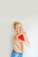 a woman holding a red heart shaped object photo