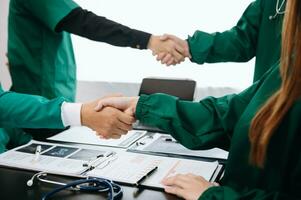 Doctor handshake and partnership in healthcare, medicine or trust for collaboration, unity or support.Team of medical experts shaking hands in teamwork for or success in clinic or hospital photo