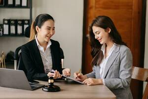 Asian business and Male lawyer or judge consult having team meeting with client, Law and Legal services concept.Customer service good cooperation in office photo