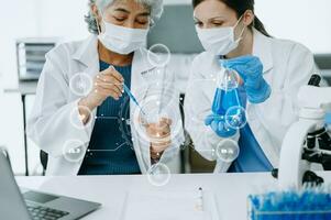 Scientist two woman with tablet and laptop, laboratory and ecofriendly science. Agriculture, research and scientists with online reading, test samples for global warming, analytics and tech. photo