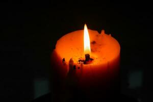 Close up view of the candles cutting through the darkness. photo