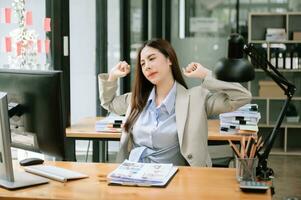 Confident business expert attractive smiling young woman holding digital tablet  on desk in office. photo