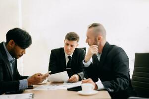 Business team discuss at meeting room. working together with laptop ,tablet and smart phone on desk Financial accountant , planner , meeting , introduction concept. At office photo