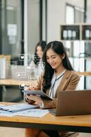 Asian woman typing smartphone, keyboard  with laptop computer of Social media and marketing virtual icons screen concept. photo