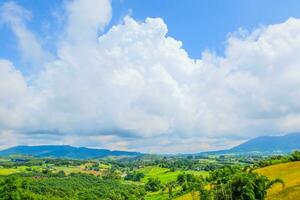 Big cloud full of sky on the mountain and Green field bright colors in country photo