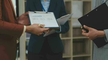 handshake of two businessmen, graphs and charts in the background. Deal, agreement concept video