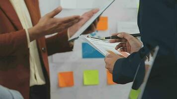 Teamwork with business people analysis cost graph on desk at meeting room. video