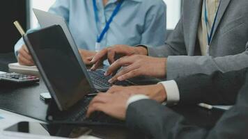 Teamwork with business people analysis cost graph on desk at meeting room. video