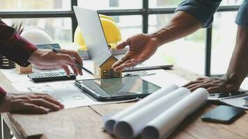 Image of team engineer checks construction blueprints on new project with engineering tools at desk in office. video