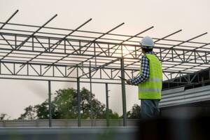 inspector or engineer is inspecting construction and quality assurance new house using a checklist. Engineers or architects or contactor work to build the house before handing it over to the homeowner photo