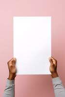 A human hand holding a blank sheet of white paper or card isolated on pink background. ai generated photo