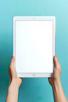 Hand holding tablet with mockup blank screen isolated on blue background. ai generated photo