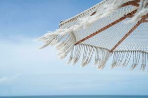 White umbrella on blue sky with clouds. photo