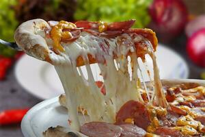 Slice of melting mozzarella pizza photo