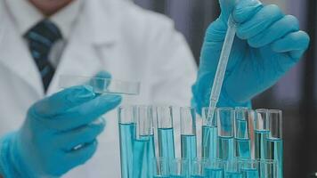 Health care researchers working in life science laboratory. Young female research scientist and senior male supervisor preparing and analyzing microscope slides in research lab. video