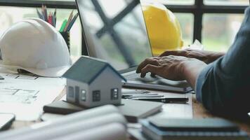 Image of team engineer checks construction blueprints on new project with engineering tools at desk in office. video